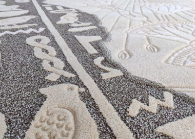 Transition from loop pile to cut pile on dual-texture rug