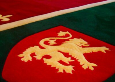 Billiard room rug fragment with British lion on red shield