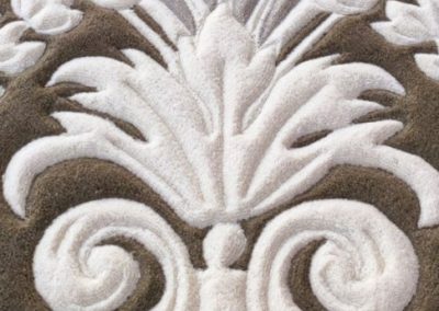 Wool rug surface showing hand-carved relief and light reflections