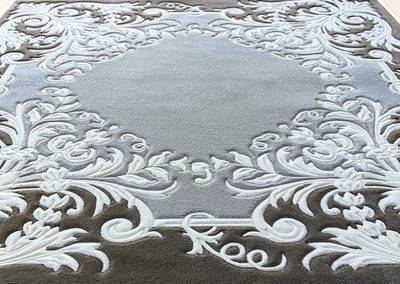 Side angle of a handmade classic square rug showing pile texture