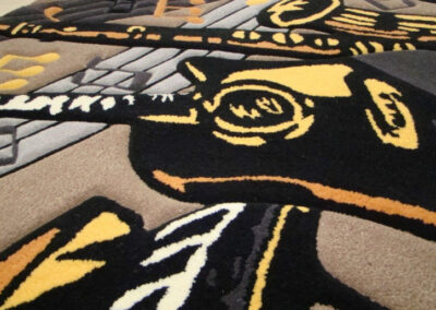 Wool carpet detail showing stylized instrument artwork
