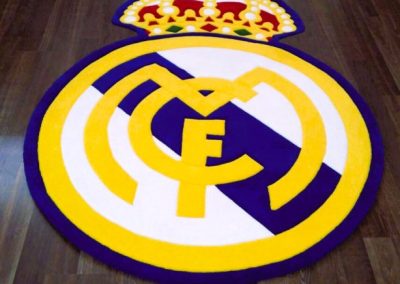 Real Madrid rug placed on the floor showing 3D relief and natural wool texture