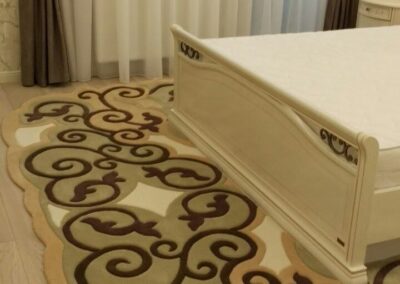 "Bedroom interior featuring wrought iron inspired rug"