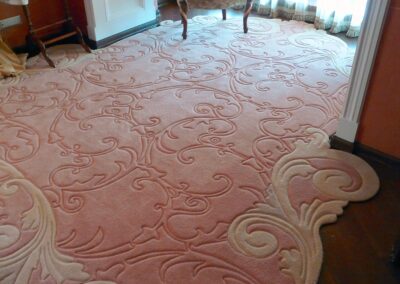 Bay window area carpet with soft pink base and carved patterns