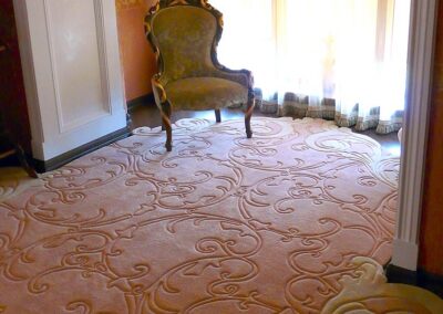 Sculpted wool rug flowing into a bay window area