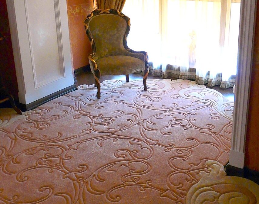 Sculpted wool rug flowing into a bay window area