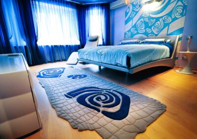 Grey blue rug with pattern and texture in bedroom interior