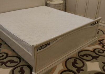 "P-shaped rug perfectly fits around the bed – top view"