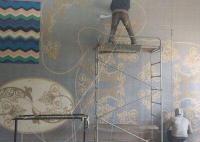 Handmade production tufting of an exclusive rug by the bar counter