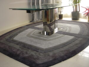 Split rug 10 shades of grey under glass table in interior